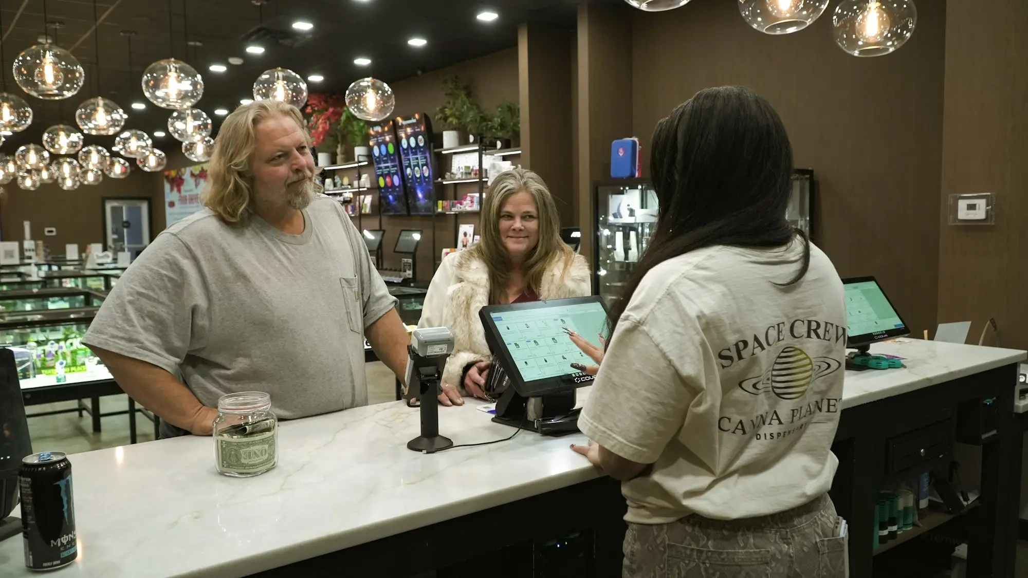 Customers served by staff at a shop counter