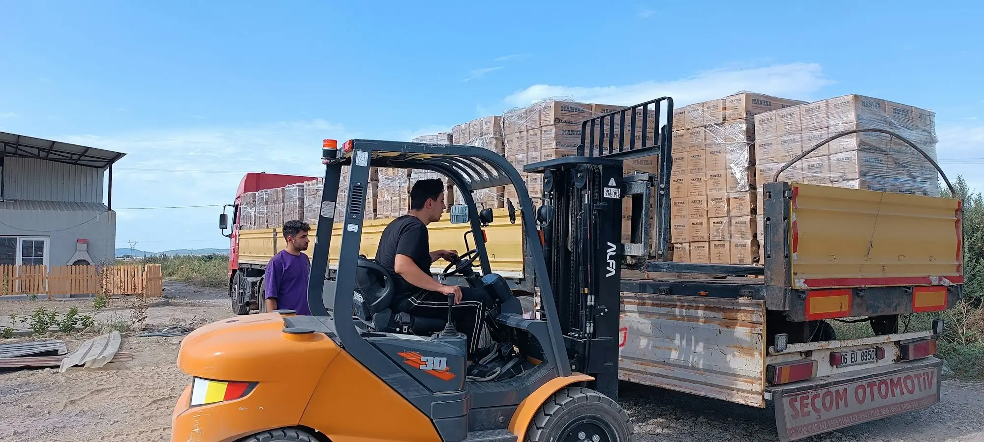 Forklift loading pallets onto a truck